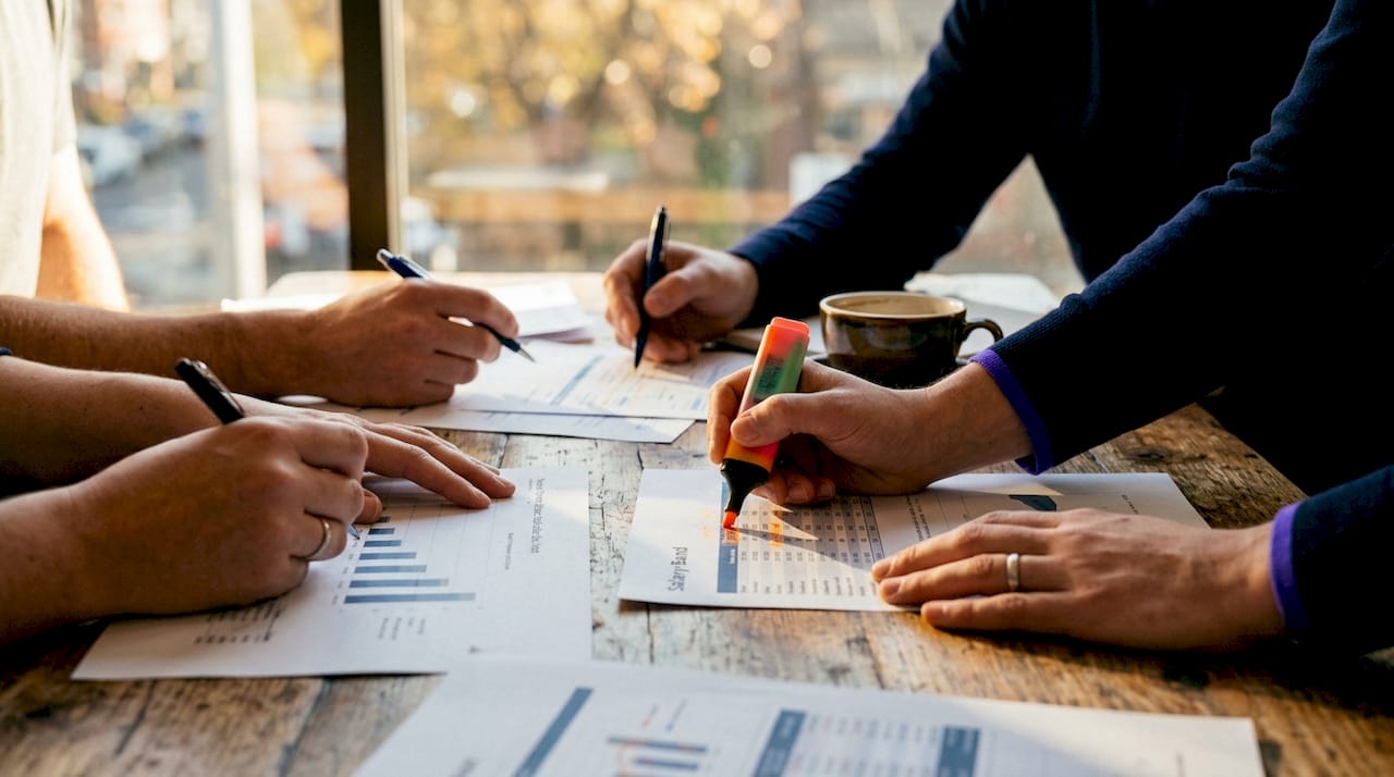 Collaborative hands preparing salary data