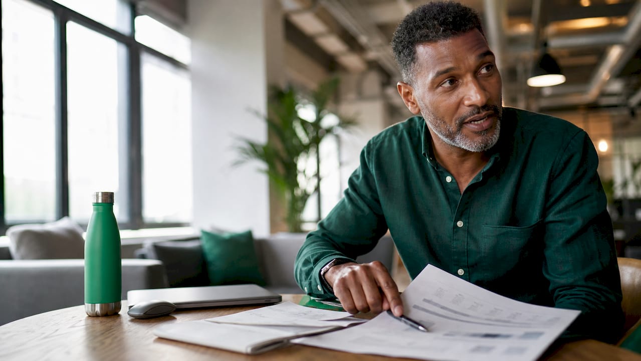 Man reviewing project management spreadsheets