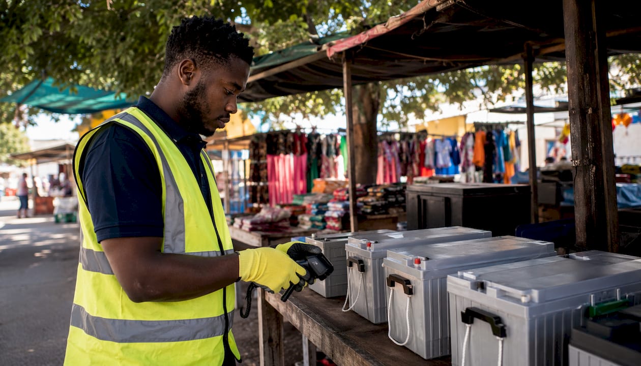 Technician scanning solar batteries in warehouse