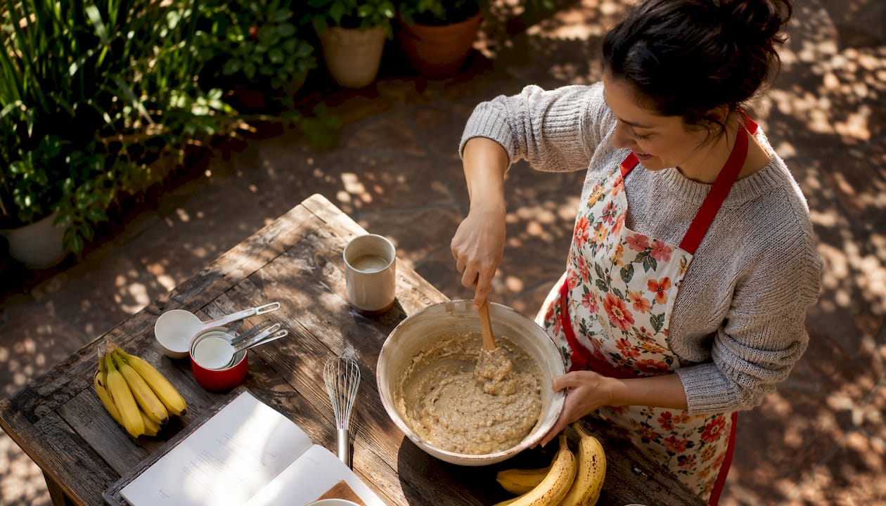 Woman preparing gluten-free banana bread batter