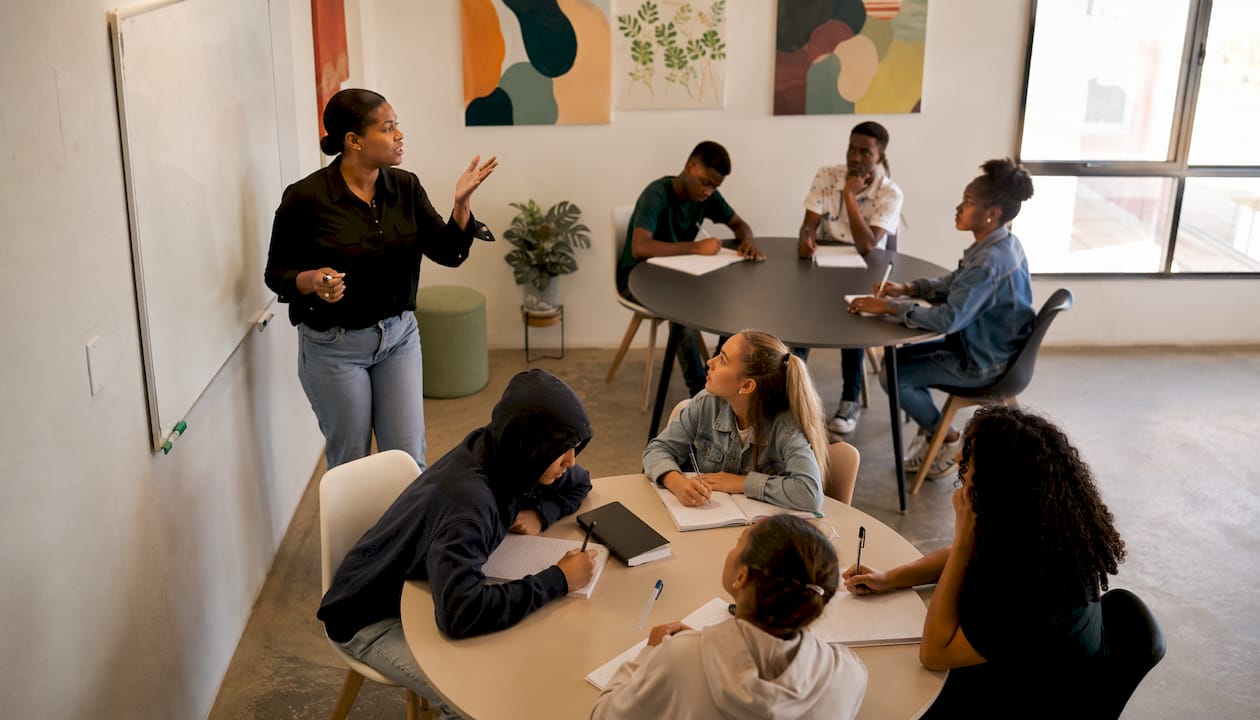 Teacher explaining matric pass levels in classroom
