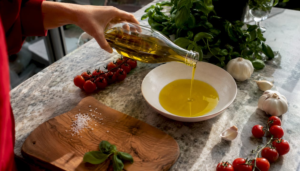 Pouring extra virgin olive oil over ingredients