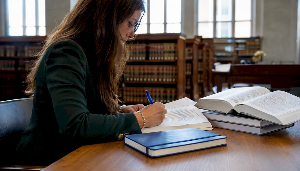 Prosecutor annotating statute legal documents.
