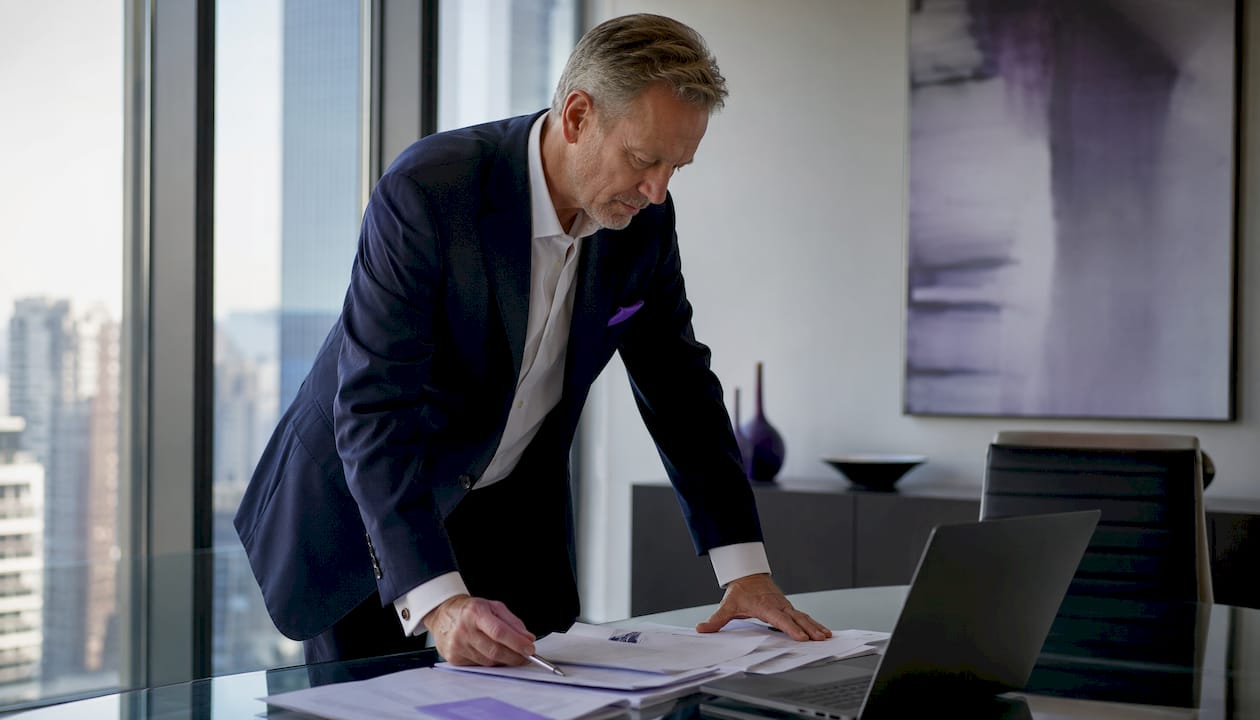 Senior CFO in executive office with city view