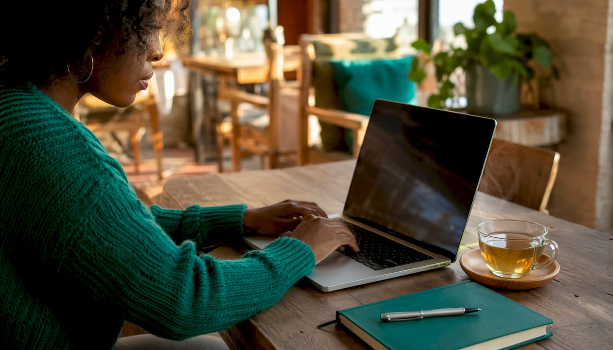 Hands typing freelancing profile headline on laptop