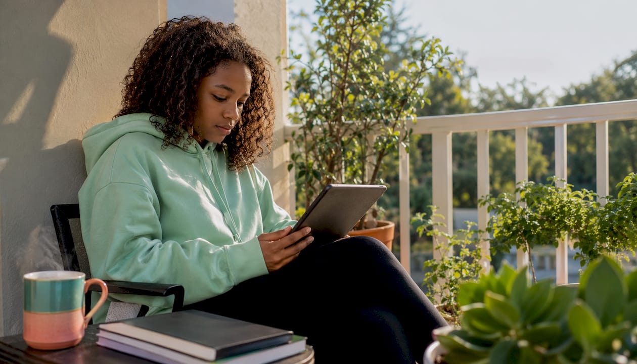 Student reading PDF on tablet at desk