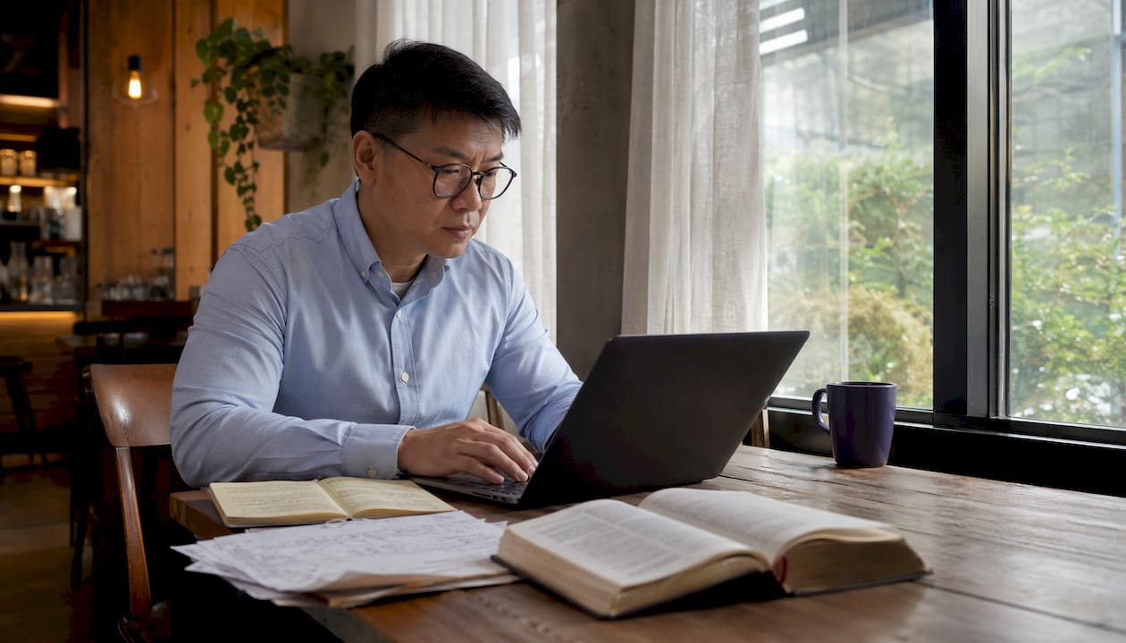 Man preparing graduation speech in home office