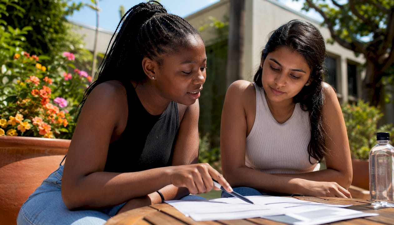 Students discussing university applications on campus