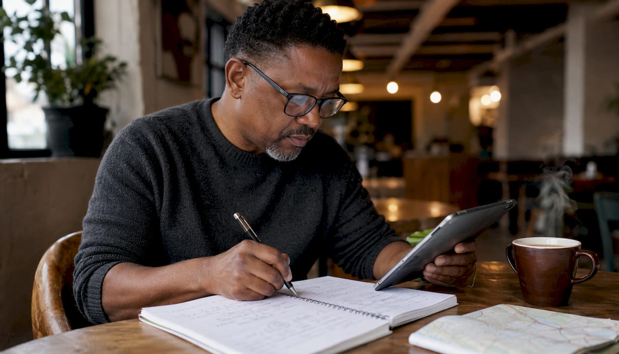 Man researching salary data at café table