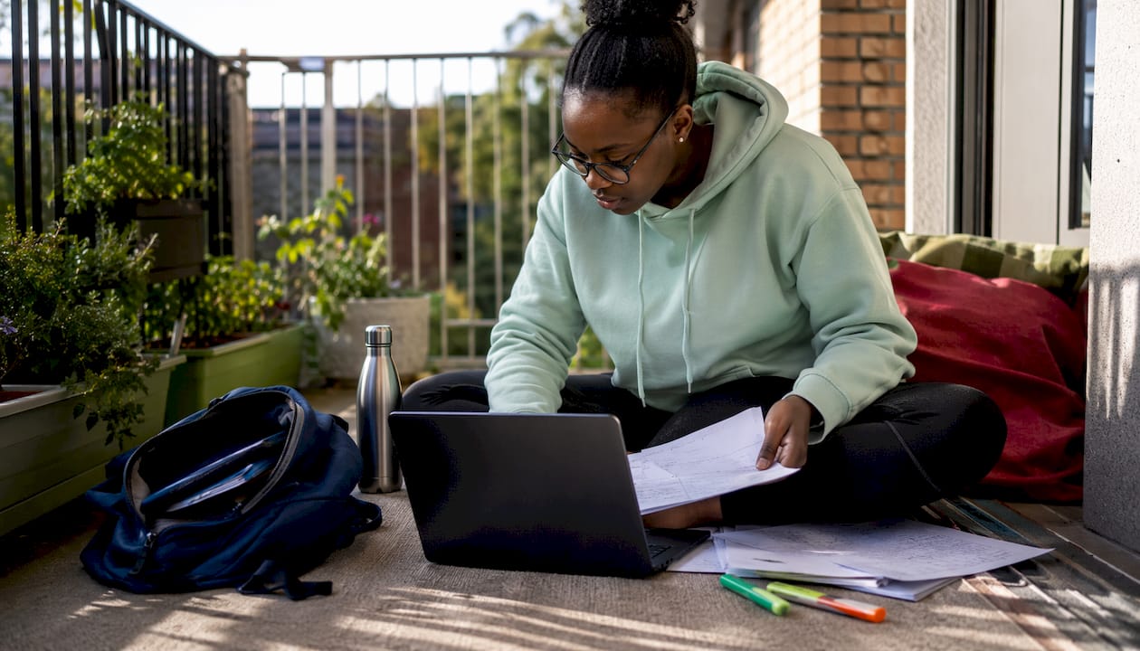 Student focused editing PDF on laptop