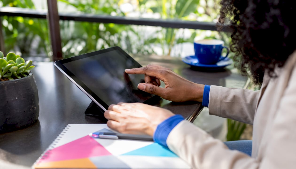 Hands setting tender search alerts on tablet