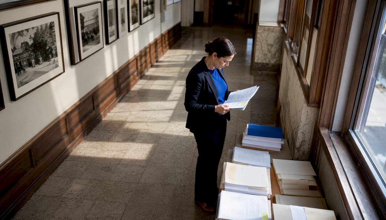 Legal researcher reviewing case files in archive