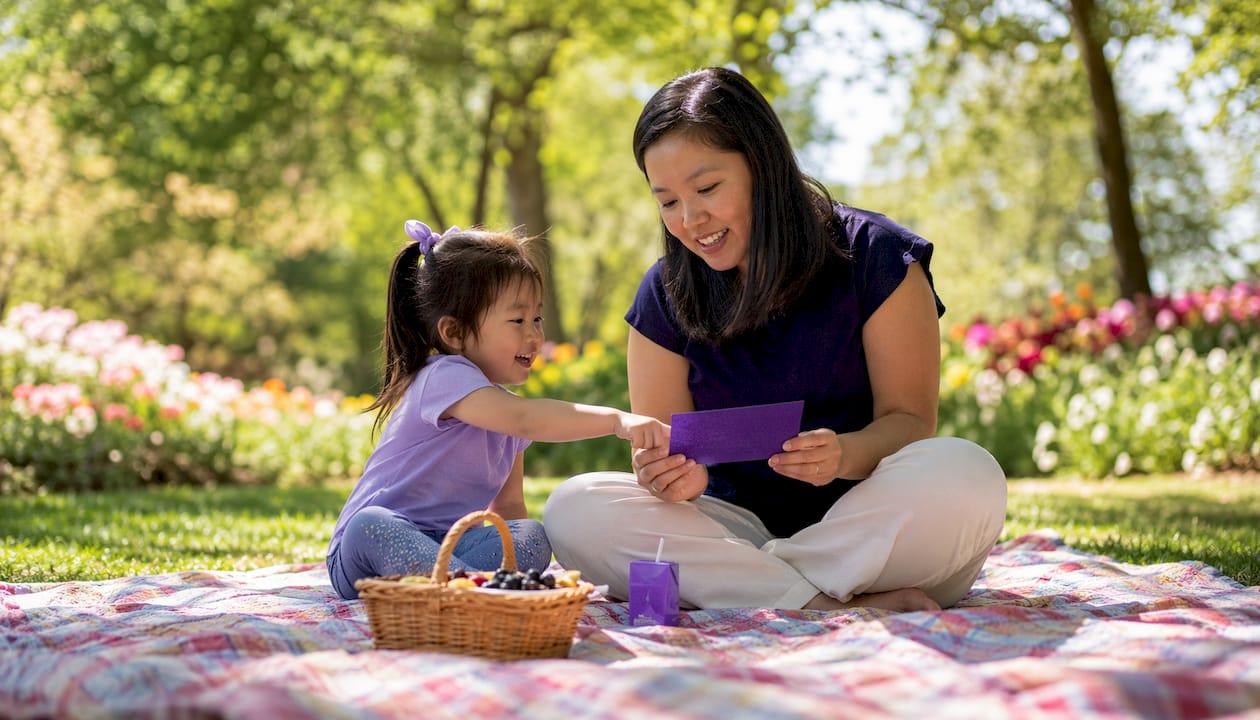 Mother teaching Bible verse to daughter at breakfast