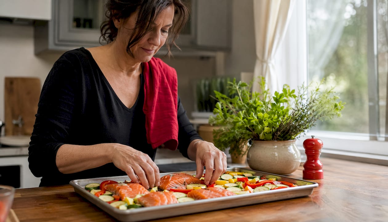 Woman preparing sheet pan chicken dinner