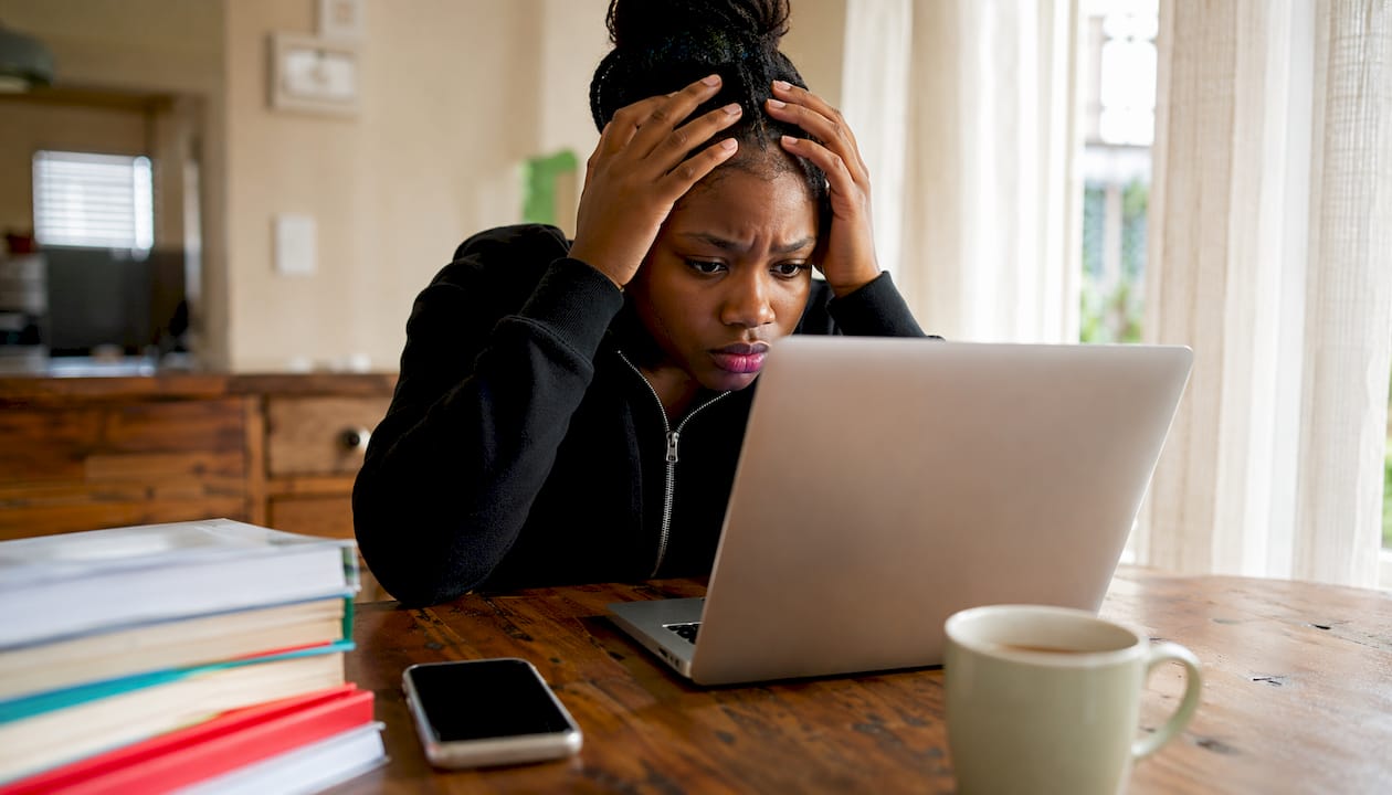 Student checking matric results on laptop