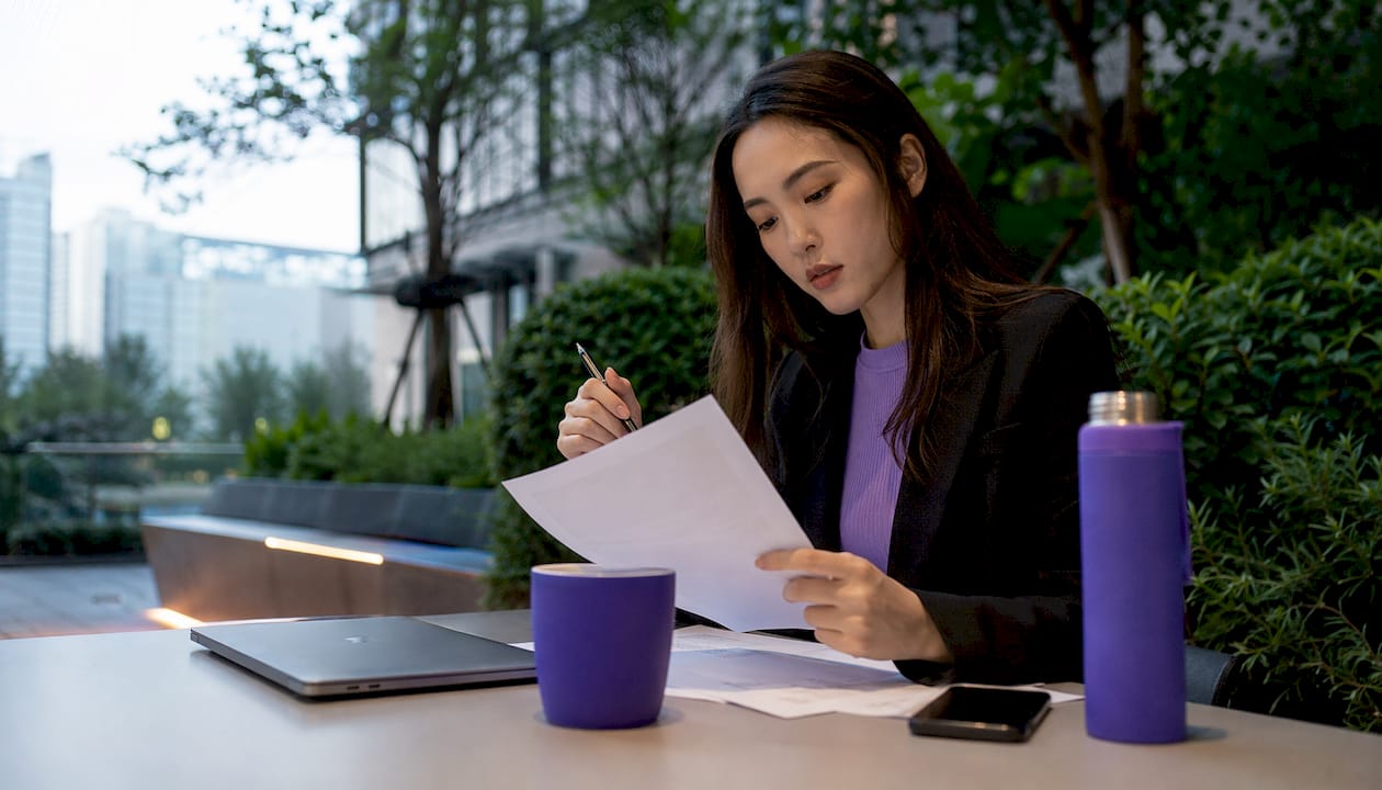 Woman reading salary contract in coworking space