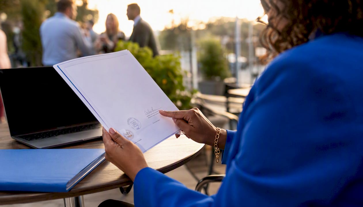 Hands reviewing signed tender documents