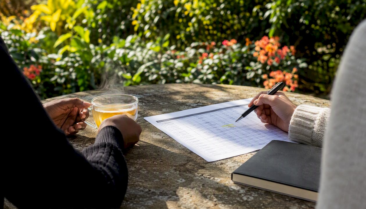 Hands pointing to late application deadlines on paper