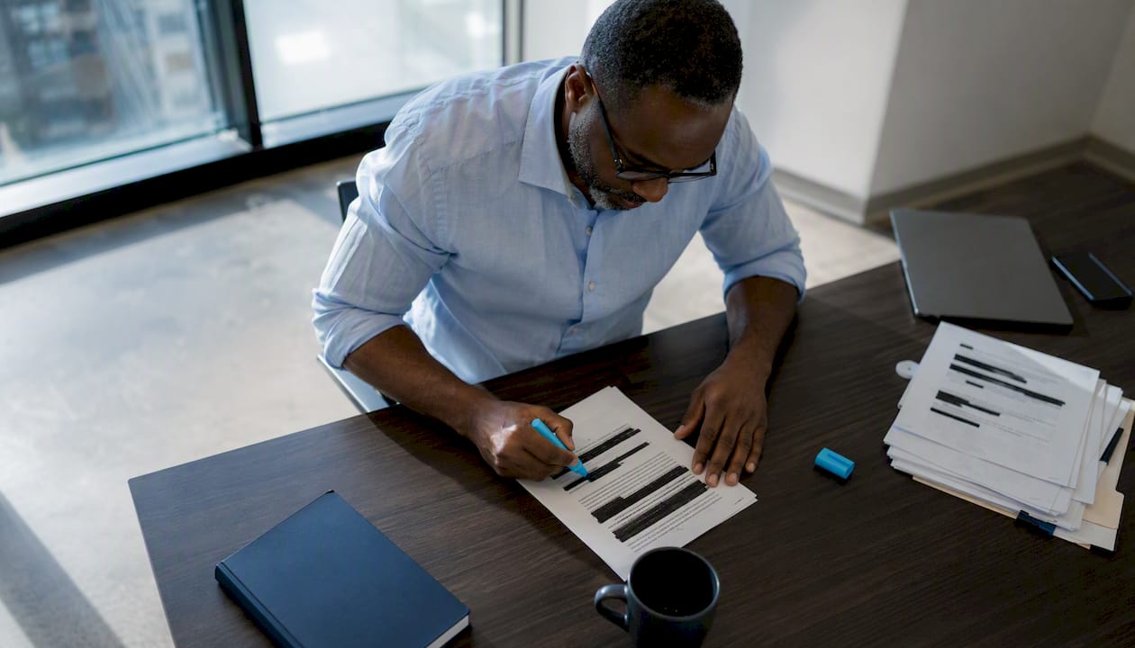 Man reviewing redacted affidavit documents