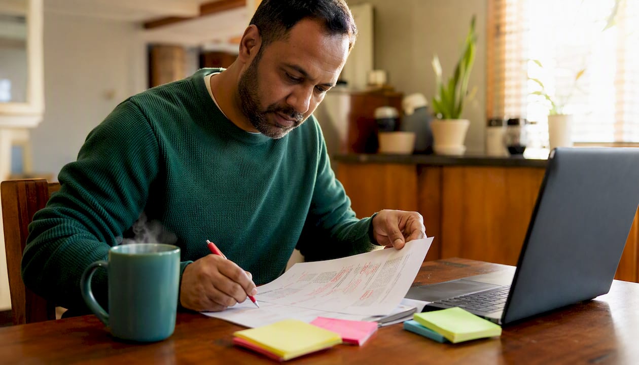 Man reviewing CV formatting errors in co-working