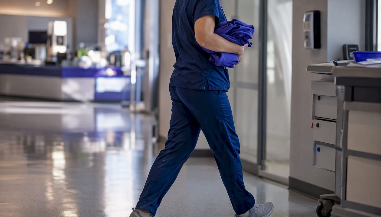 Nurse walking corridor during shift change