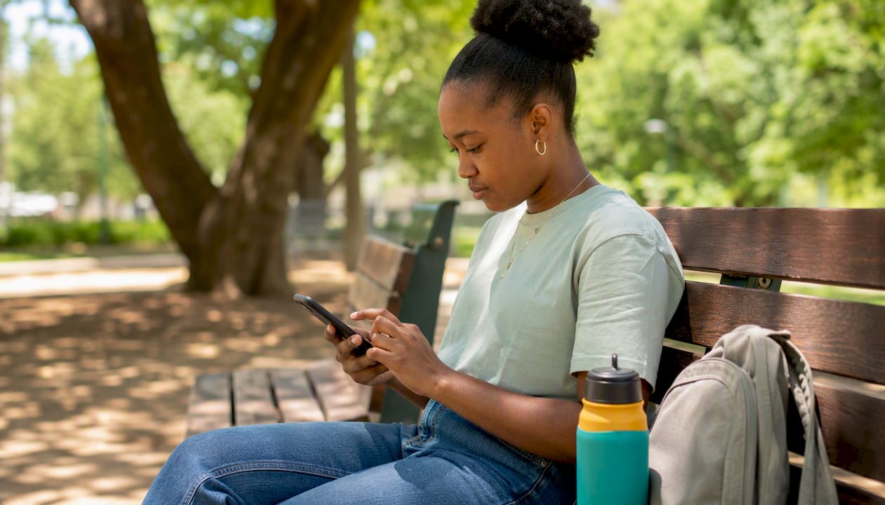Person tapping smartphone to confirm WhatsApp alert