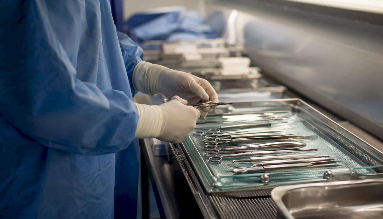 Surgeon’s hands arranging surgical tools