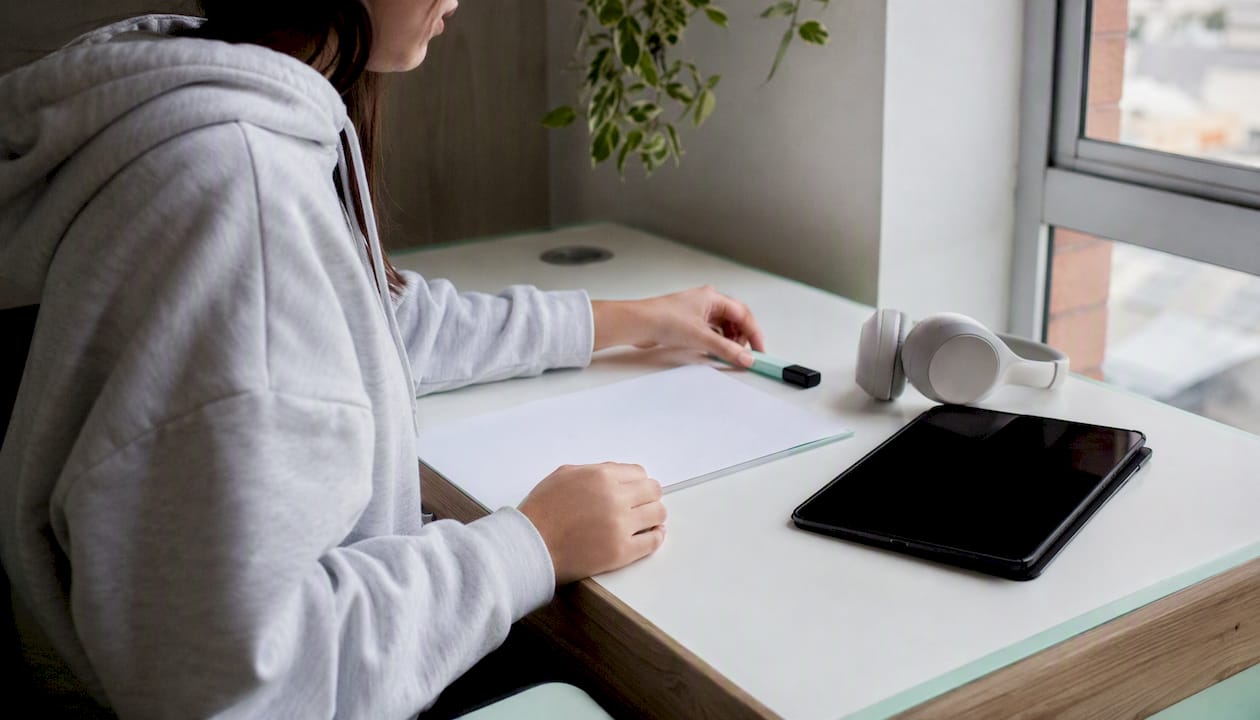 Student hands organizing exam study materials