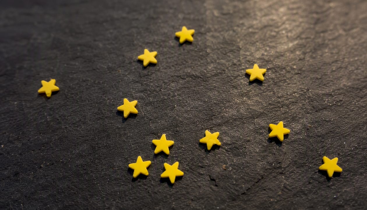 Solid yellow star confetti on dark surface