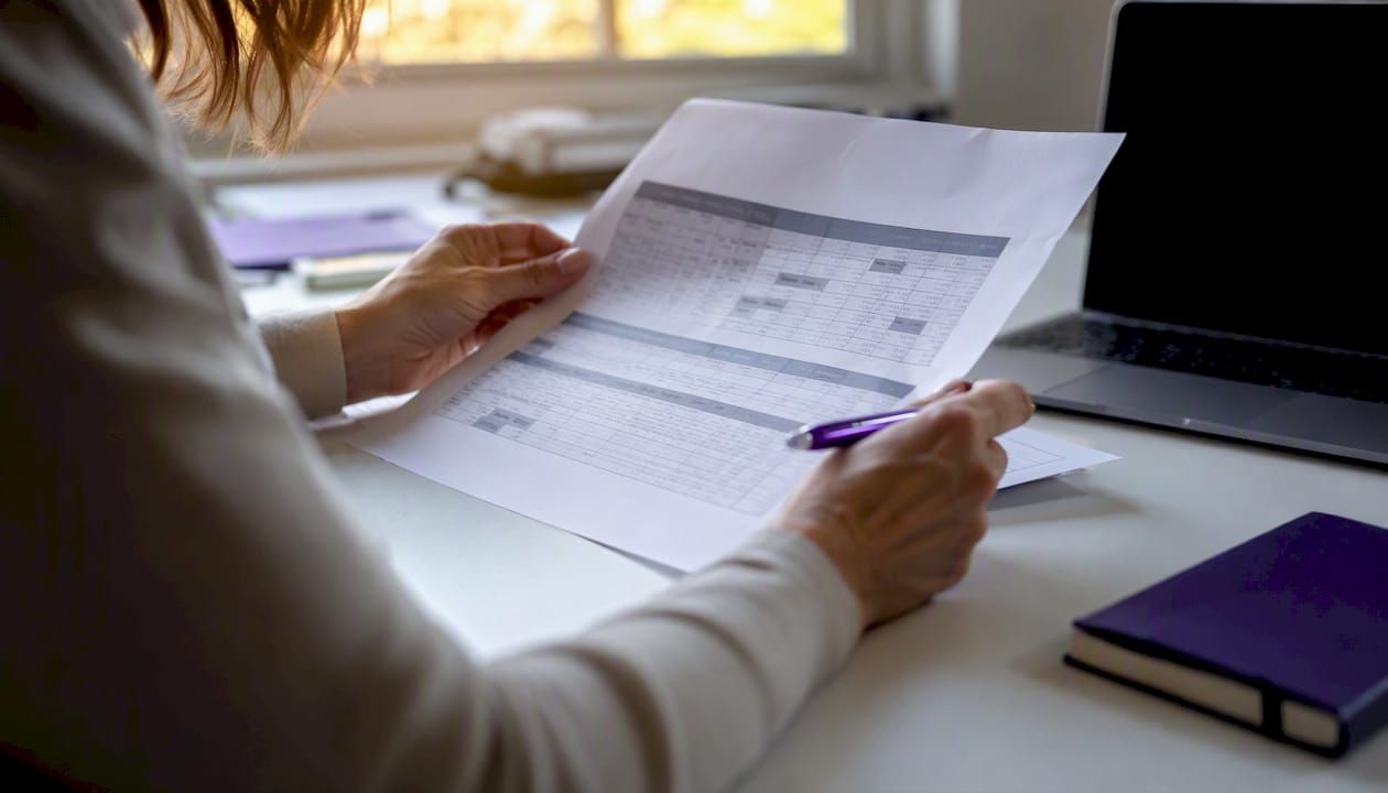 Hands verifying employee shift schedules