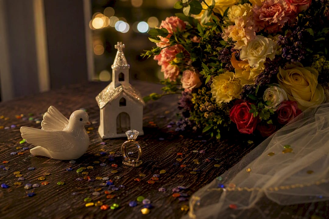 Wedding symbols on dark surface with confetti