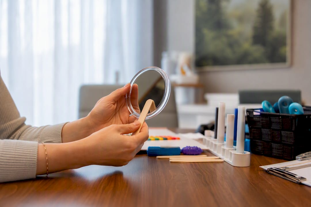Hands performing speech therapy exercise