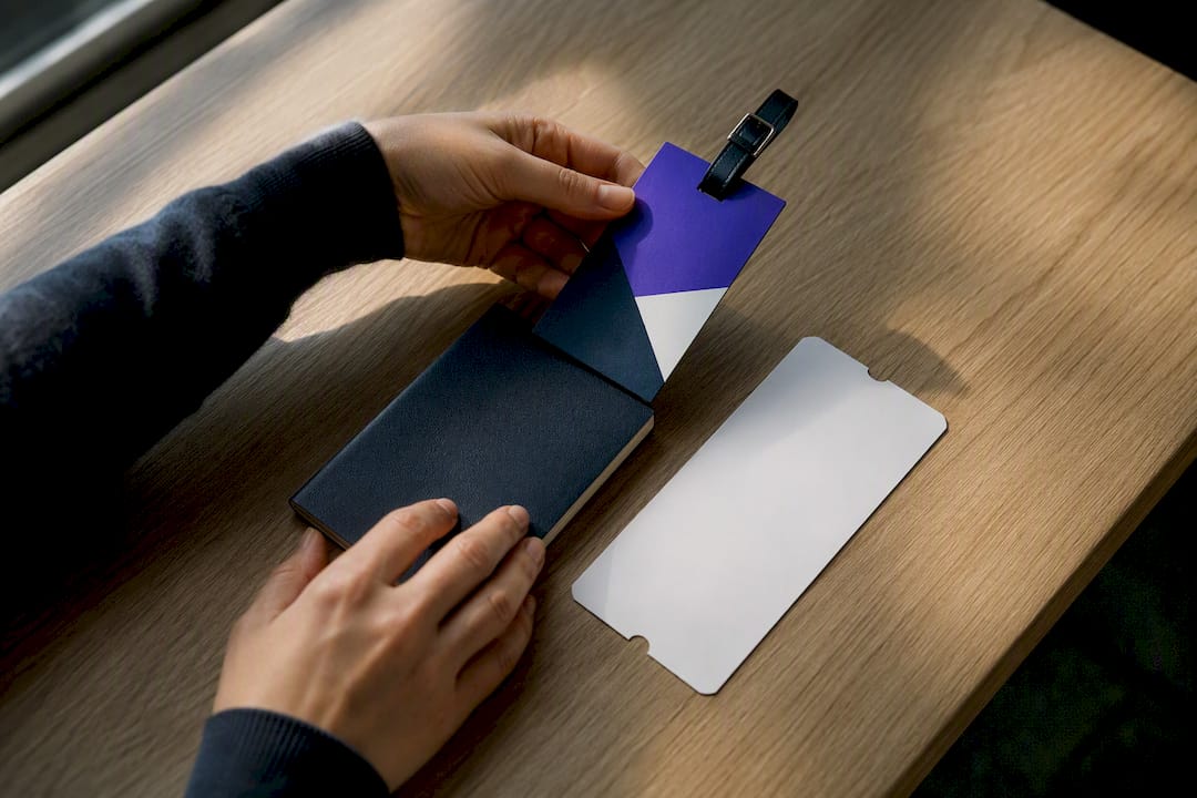 Hands preparing travel documents and luggage tag