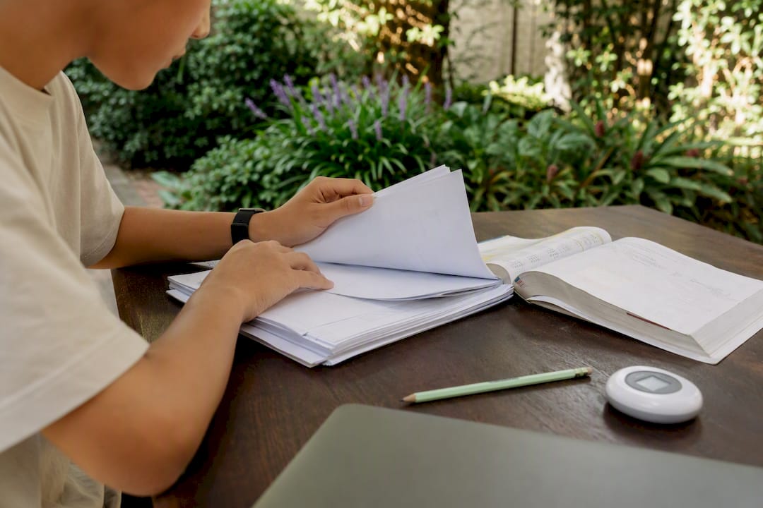 Student arranging study materials on a desk