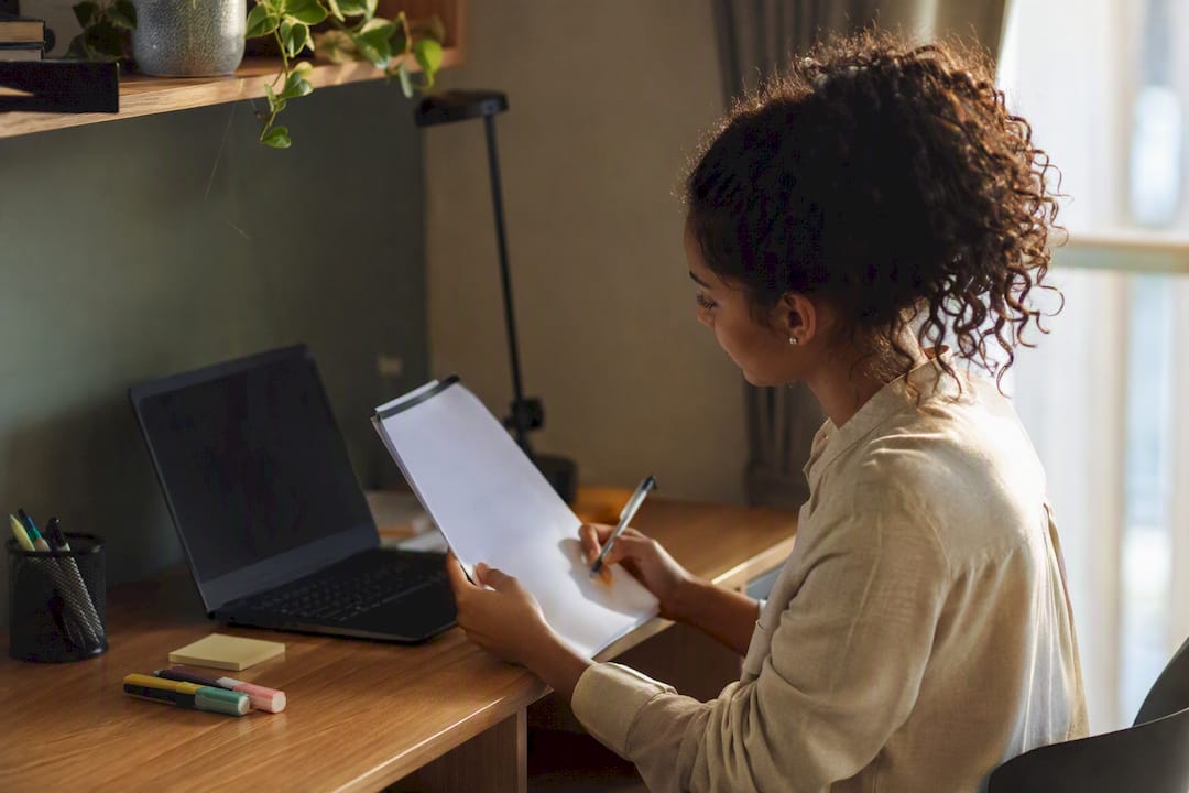 Register document next to laptop for college checking