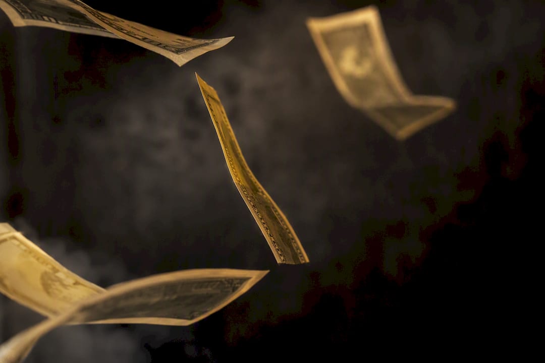Paper money bills floating away