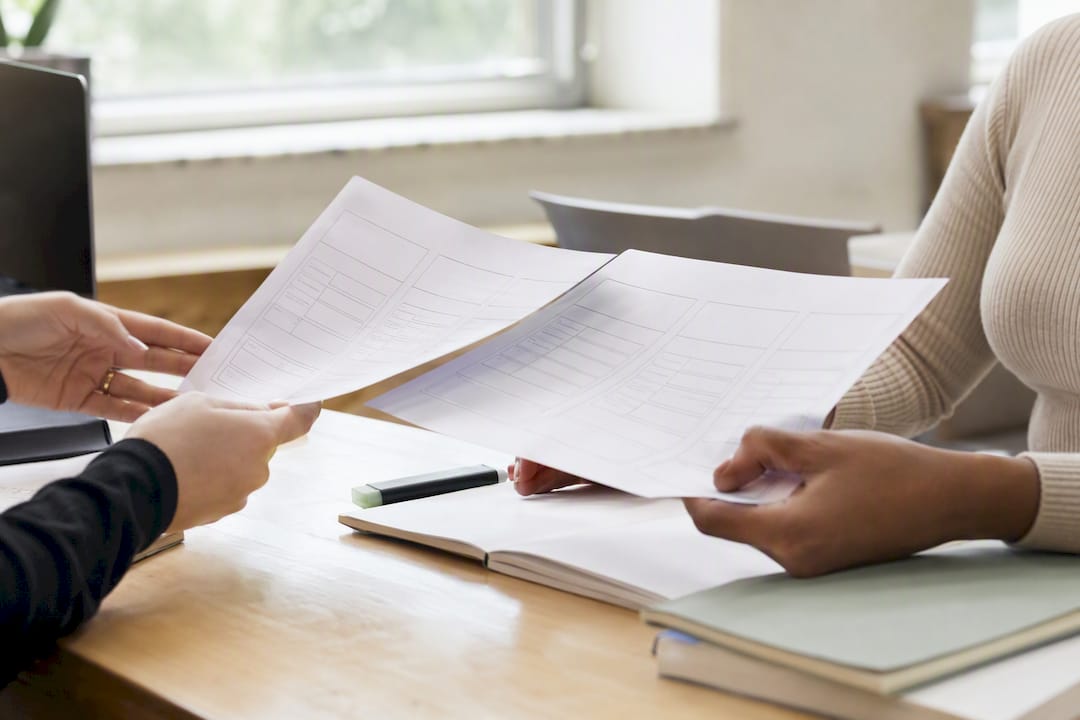 Hands comparing two module outlines side by side