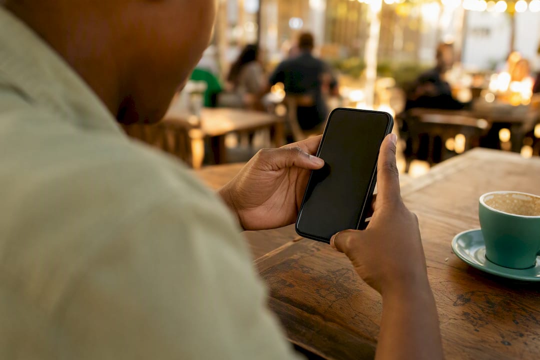 Hands navigating WhatsApp on smartphone