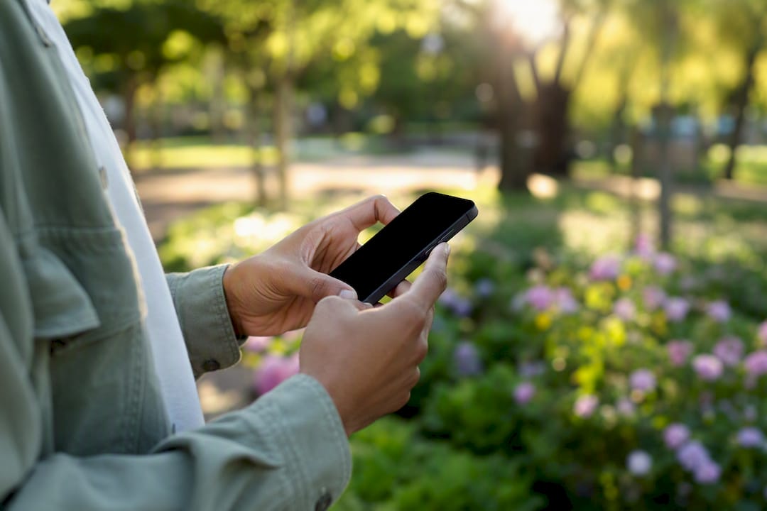 Close-up of hands capturing screenshot on smartphone