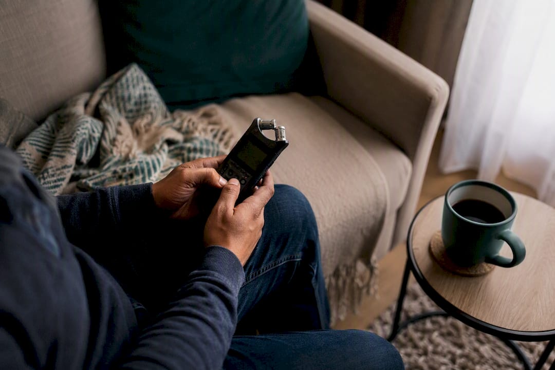 Hands holding voice recorder device