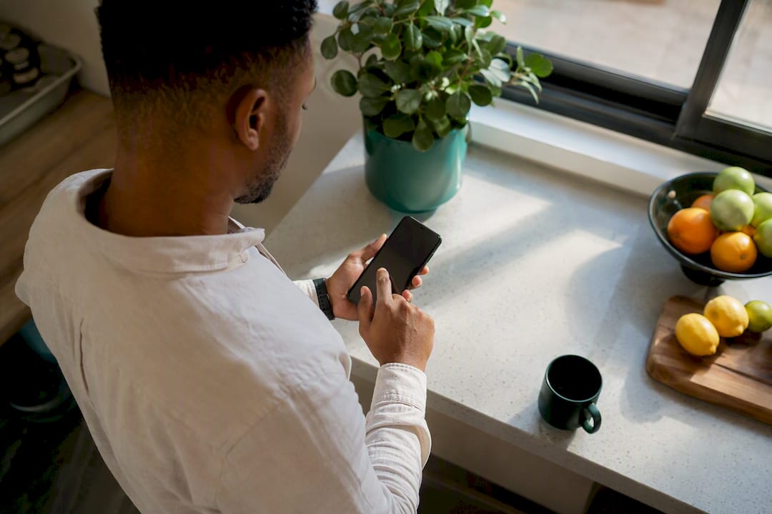 Hand tapping smartphone for job alerts