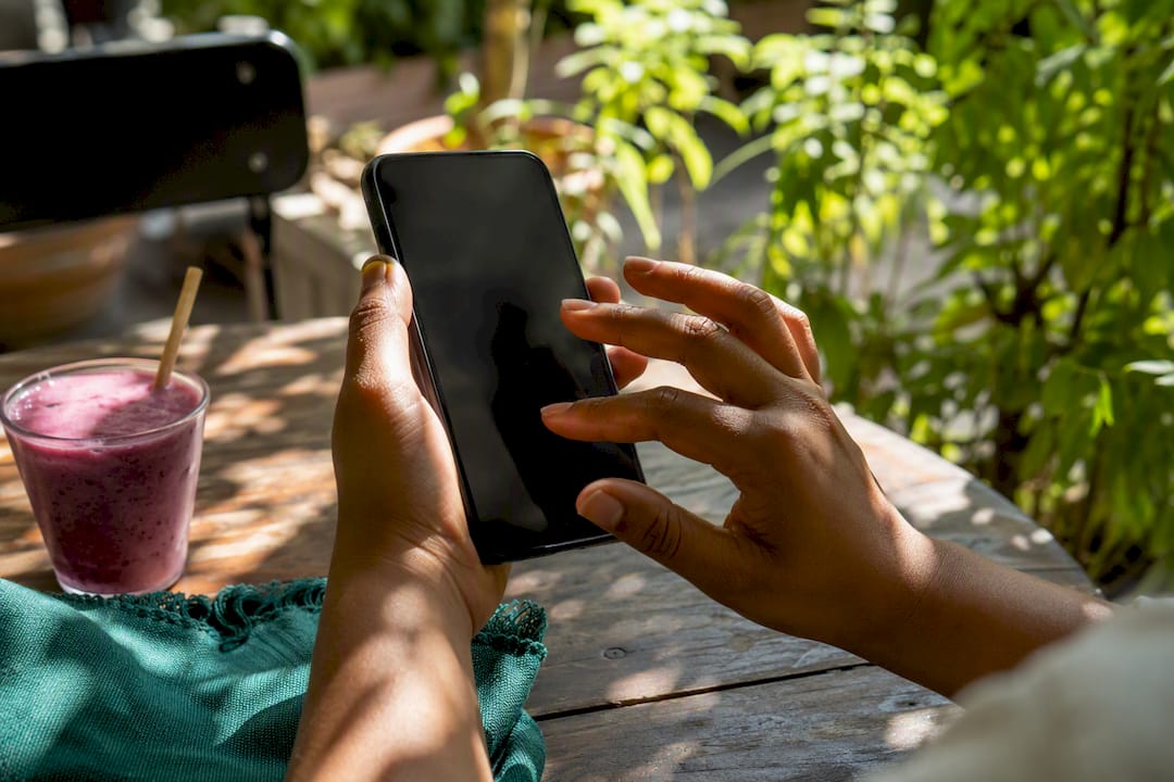 Hands setting job alerts on phone
