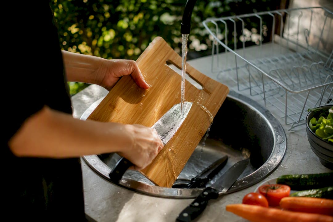 Hands washing kitchen knife to prevent illness
