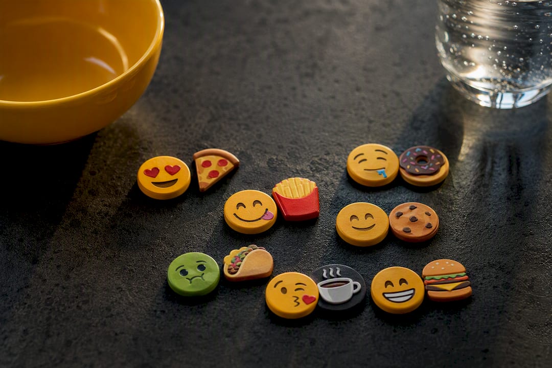 Food emoji tokens combined creatively flat lay
