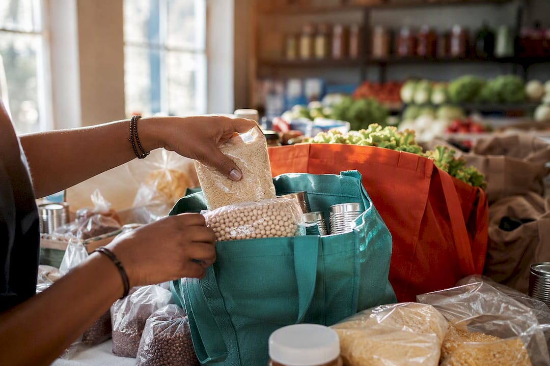 Hands packing food donations at community center