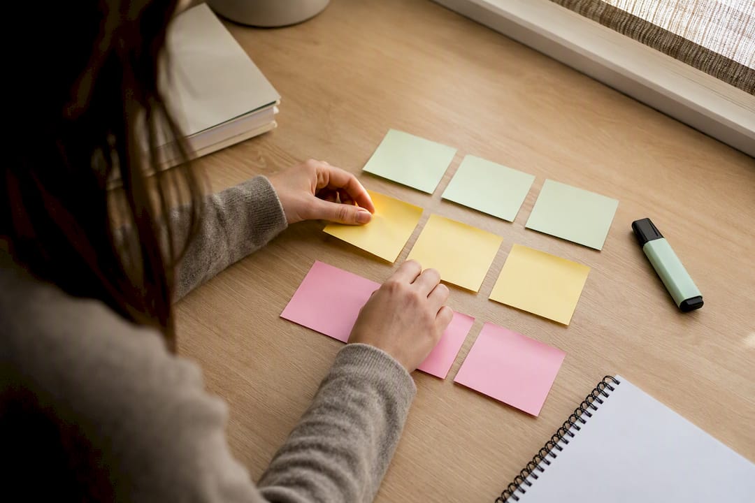 Hands arranging index cards for exam answers