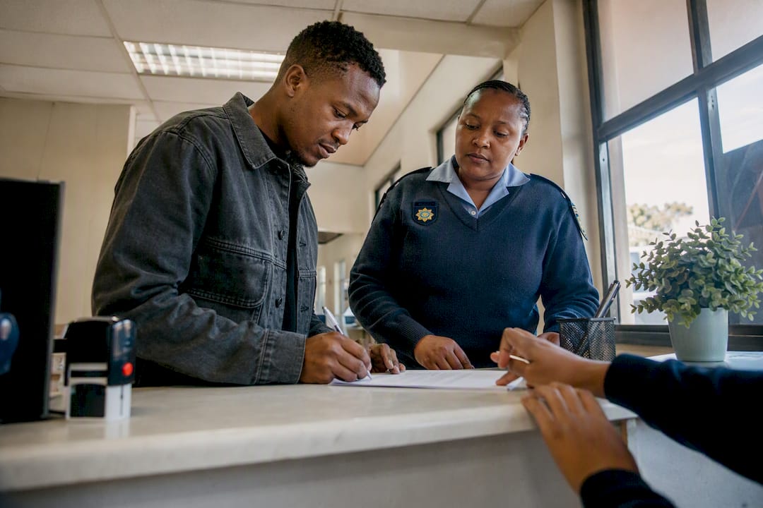 Applicant swearing affidavit at police station