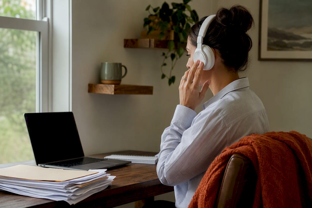 Hands holding headset preparing for remote call