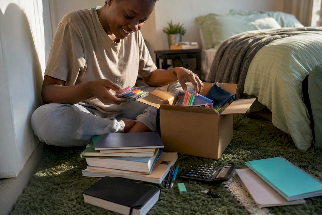 Student unpacking bursary study supplies