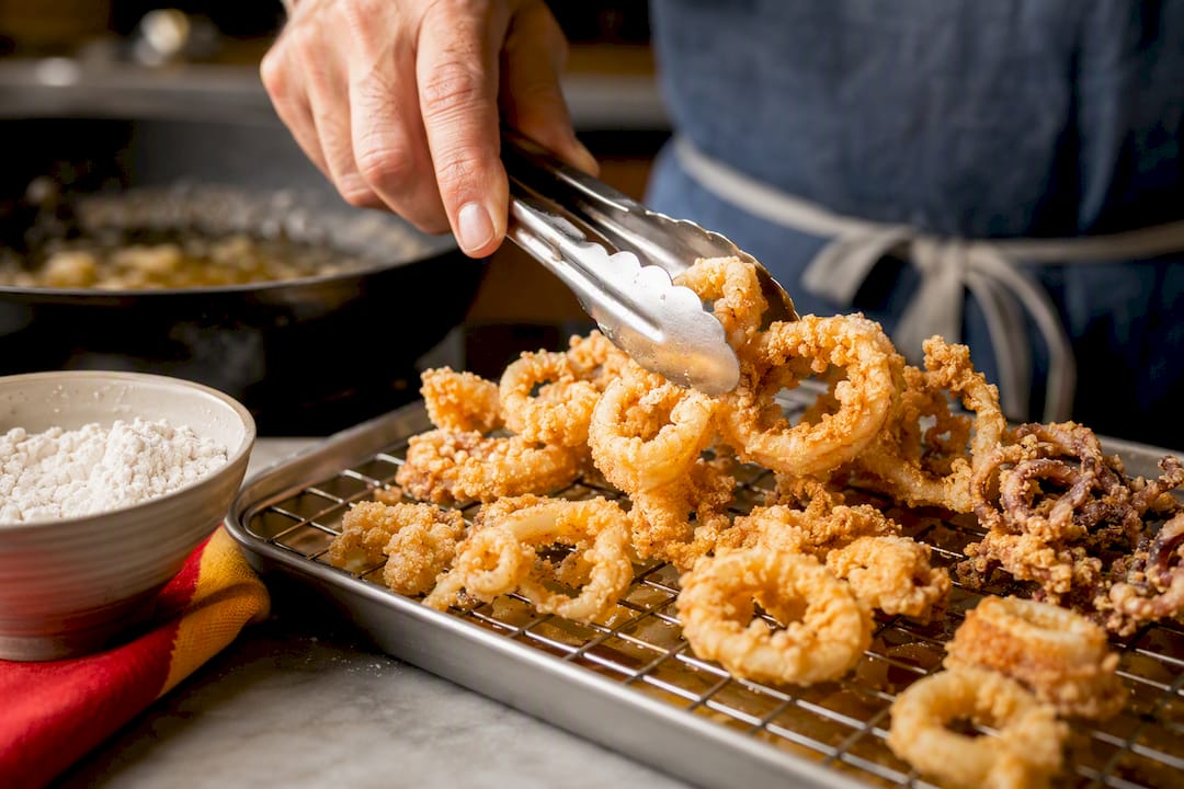 Crispy starch-coated calamari on cooling rack